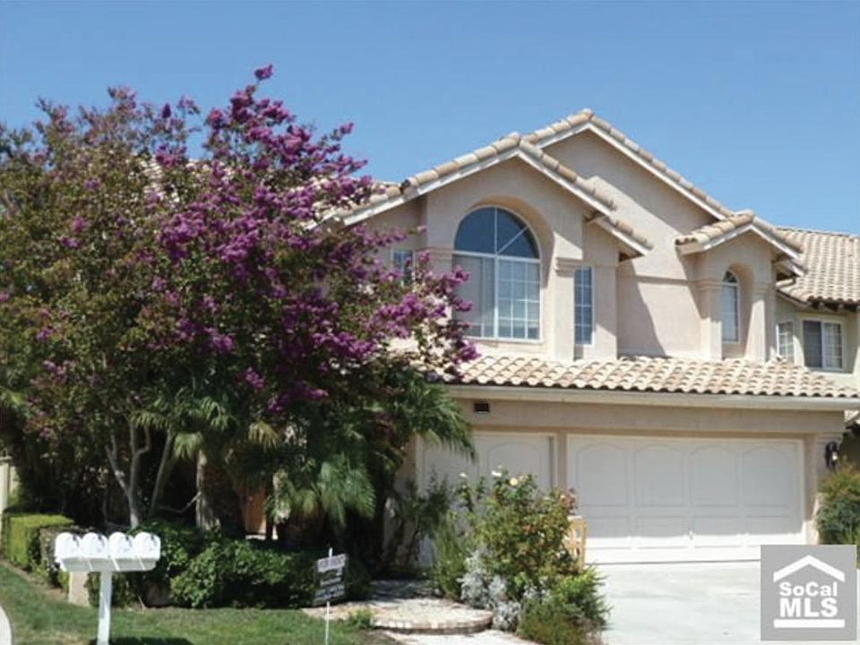 Home is now tan w dark brown doors. .new landscaping