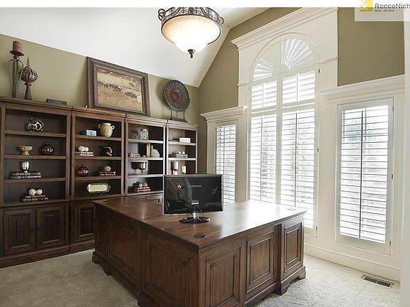 Main floor office w/ plantation shutters.