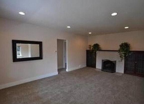 large living room built in bookshelves and fireplace
