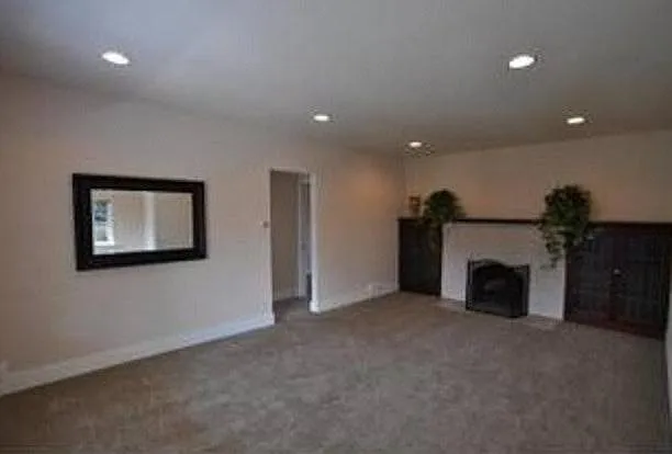 large living room built in bookshelves and fireplace