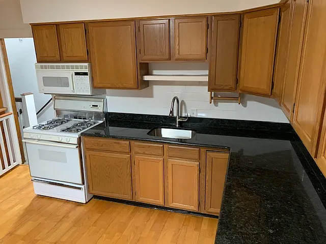 Kitchen. APPLIANCES WILL BE REPLACED AND UPDATED before move in! Gate has been removed