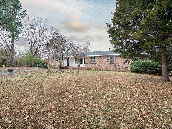 Large front yard with mature pines and evergreens.