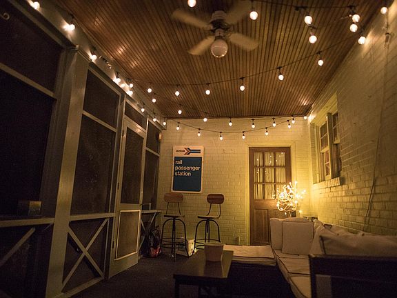 Screened porch with beadboard ceiling and ceiling fan.