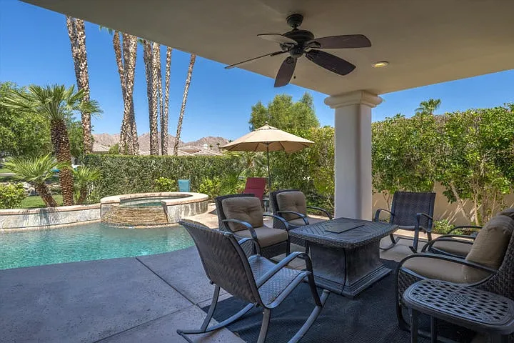 Covered patio area with custom seating furniture and fire table