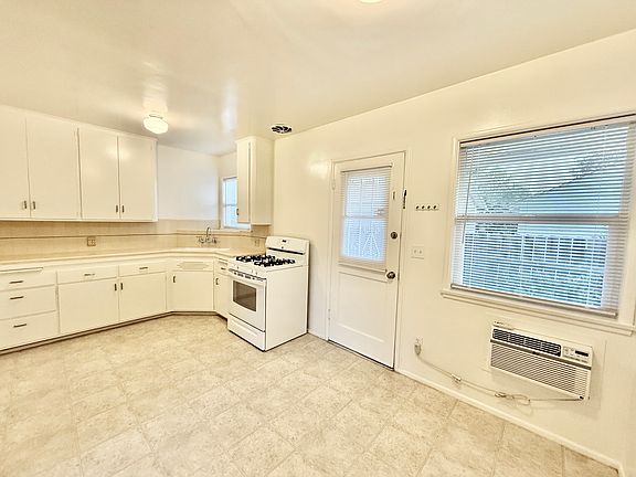 Kitchen is clean and open. Good storage, and counter space, super clean stove, door to the backyard and windows for plenty of air and light. AC unit works great.
