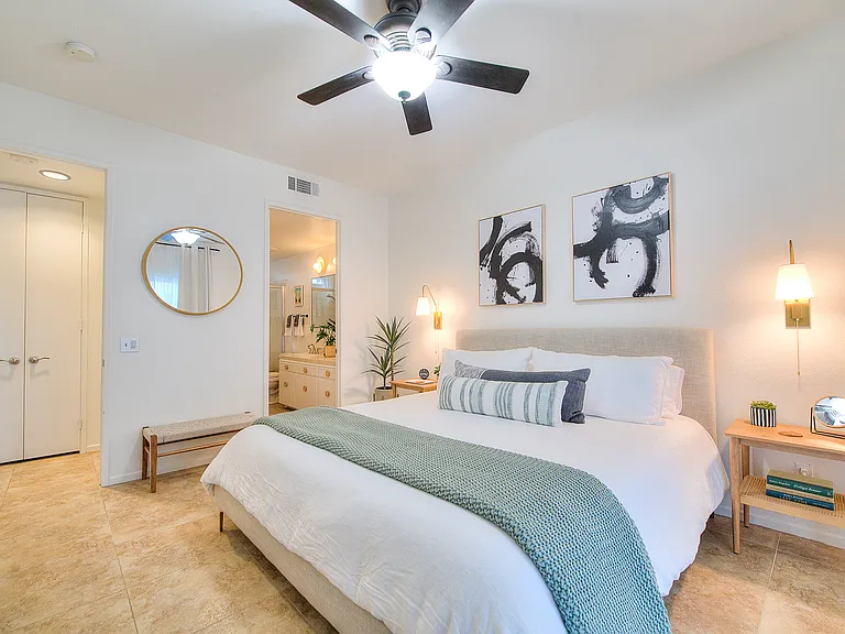 Primary bedroom with view of ensuite bathroom. To the left side is the hallway where the washer/dryer is