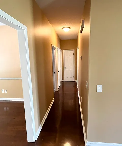 Hallway to 2 bedrooms, linen closet, and laundry room