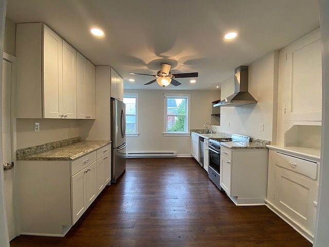 Large bright kitchen with new cabinetry and flooring