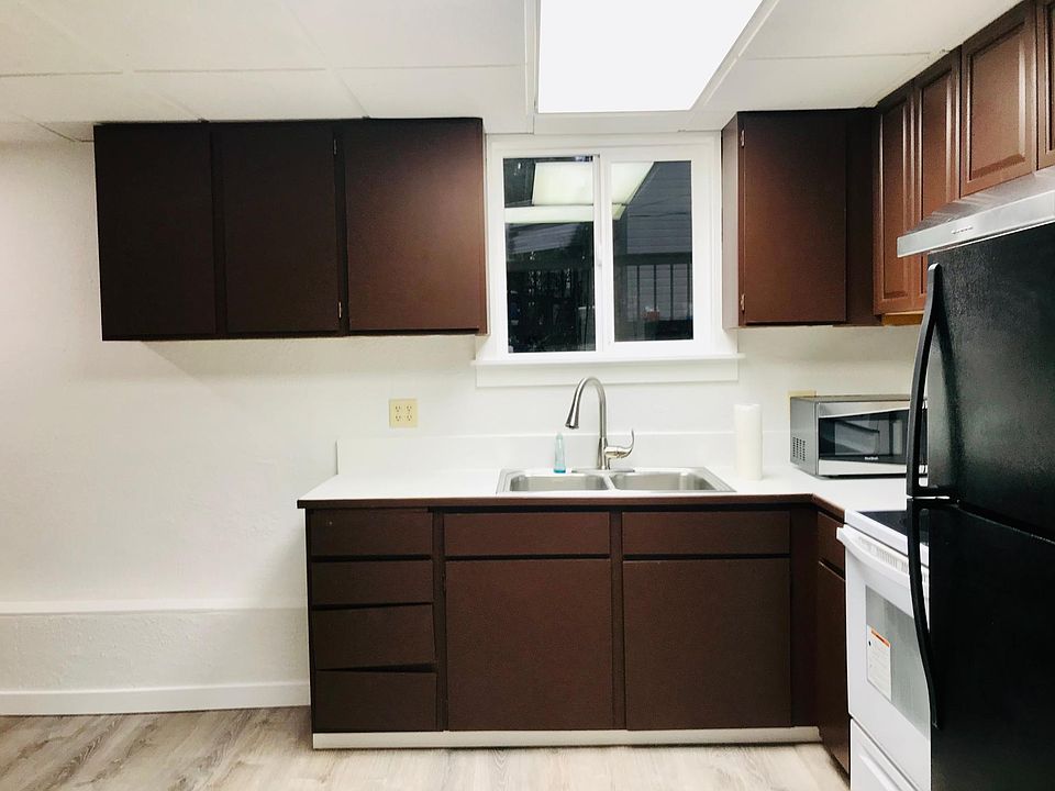 Kitchen - stove, refrigerator, microwave, and range.