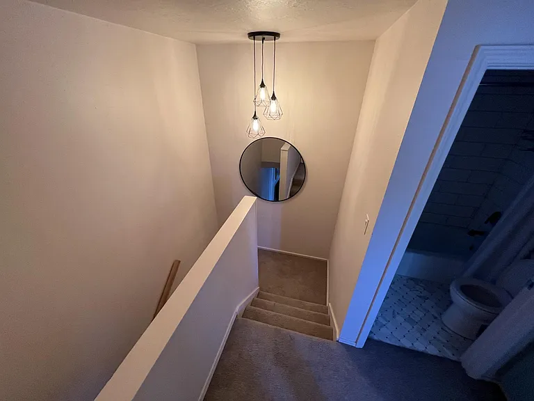 Staircase to upper level with the two bedrooms/full bathroom