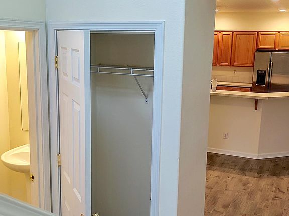 Half bath, coat closet, kitchen, patio door