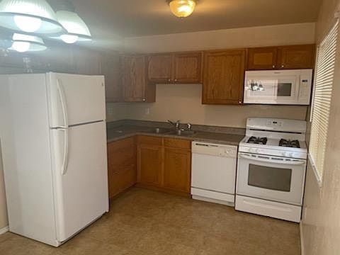 Kitchen with lots of cabinets & gas stove.