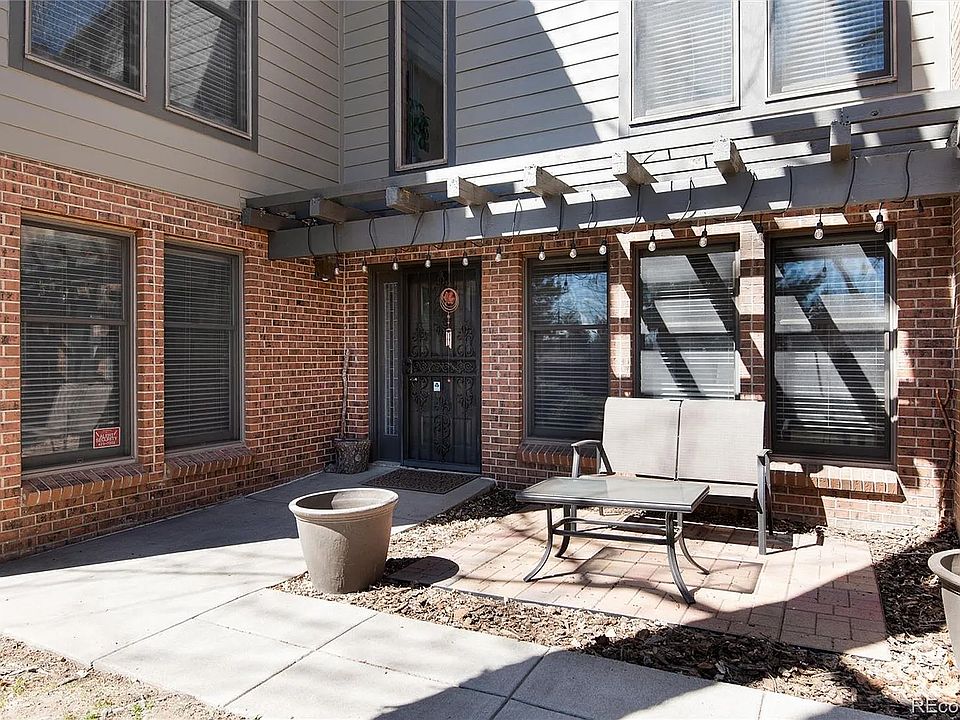 front entry of townhouse with patio furniture and pots that you can fill...