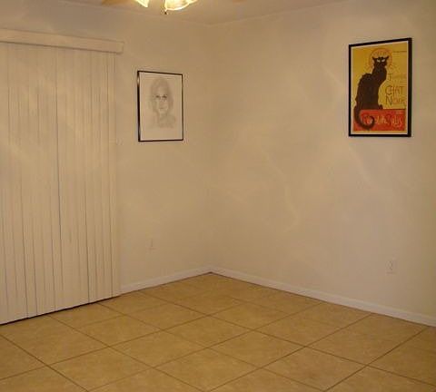 Living room area w/sliding door leading to fenced, brick paved backyard