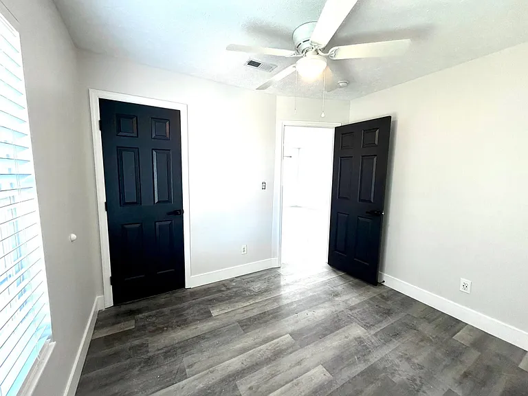 Bright and airy secondary bedroom with ceiling fan