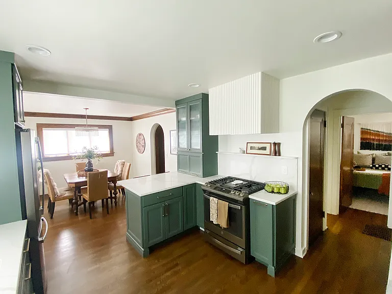 The stunning kitchen flows into a formal dining room that seats six, perfect for intimate gatherings. The space is accented by elegant arched doorways that lead to cozy bedroom, full bathroom and living room.