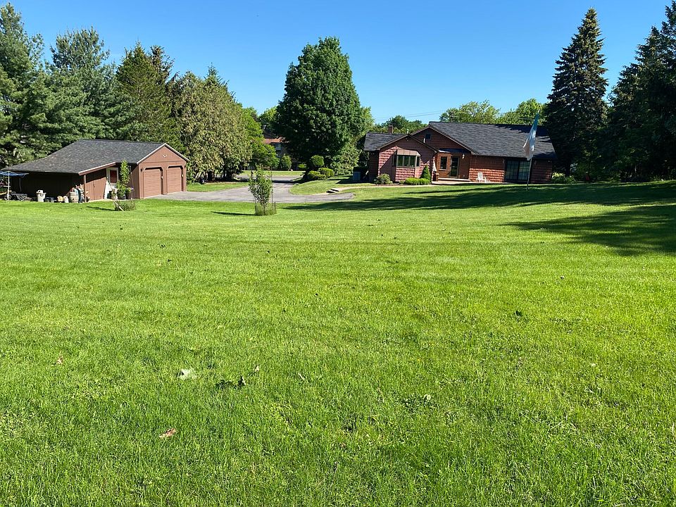 garage with shed to left and house to the right