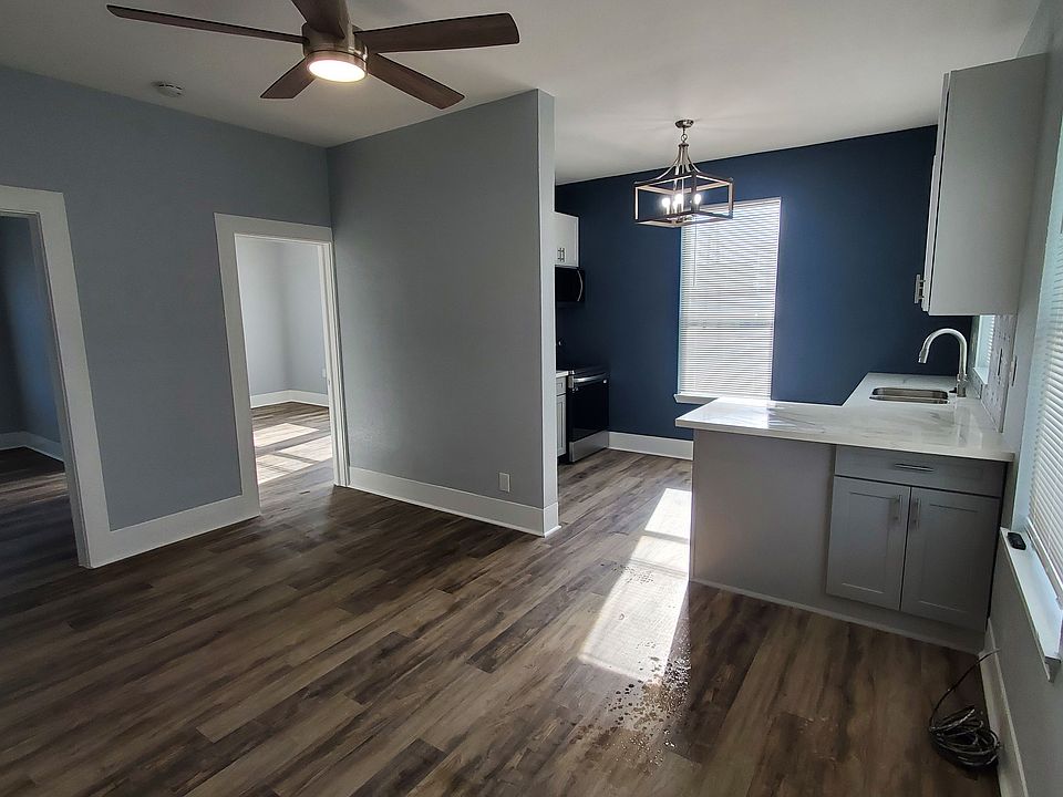 View of the living room, kitchen, and bedrooms from the bathroom entry