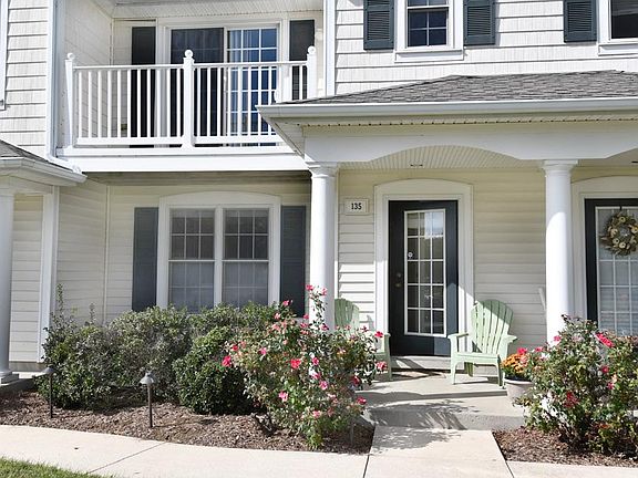 Pretty patio with mature rose bushes.