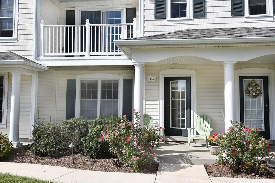 Pretty patio with mature rose bushes.