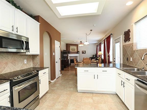Kitchen opens to Family room which has cozy fireplace!