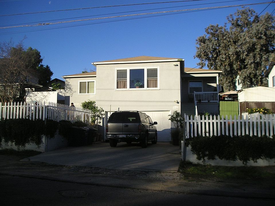 Front View with fenced front yard, 2 car garage.