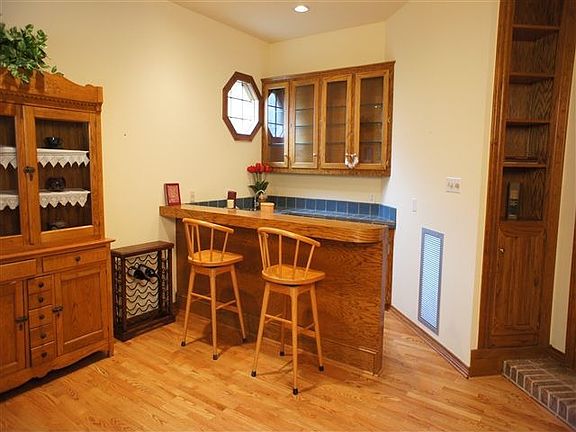 A large wet bar in the corner of this gameroom makes for fun entertaining