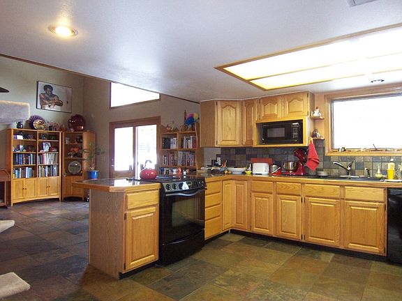 The spacious kitchen has slate flooring, and granite tile counters.