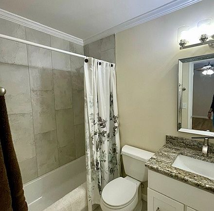 Bathroom With Granite Countertops, Porcelain Tile Floor and Shower