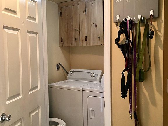 1st floor 1/2 bath with storage and washer dryer that are included with the property.