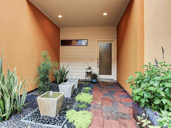 Fresh landscaping, soothing fountains, paver walkway and recessed lighting greet you as arrive home