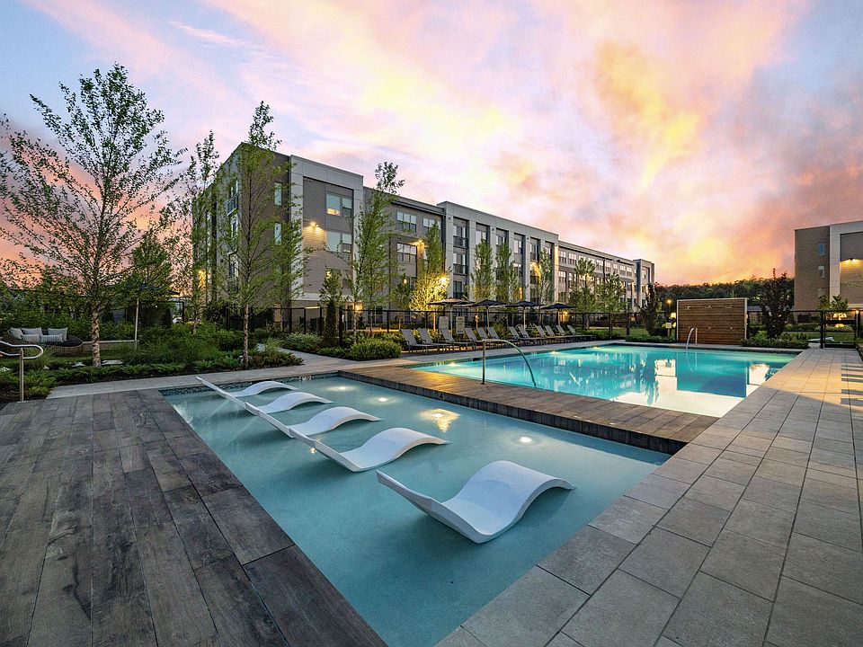 Resort-style pool featuring both in-pool sun loungers and day beds