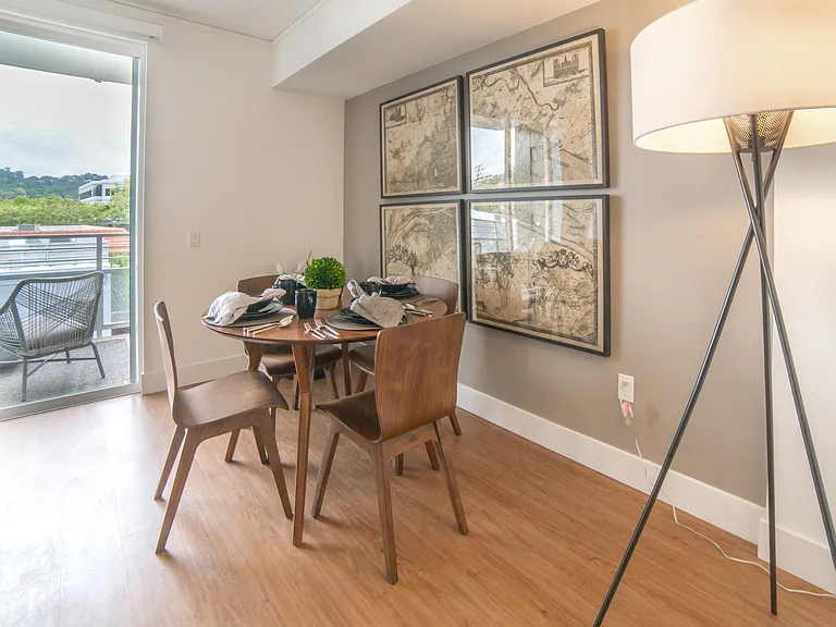 Floor to ceiling windows and beautiful wood-plank style flooring