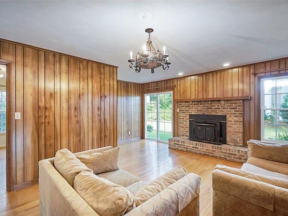Large Family Room with wood burning stove and slider door entrance to yard
