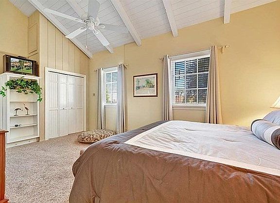 Master bedroom with vaulted ceiling and closet