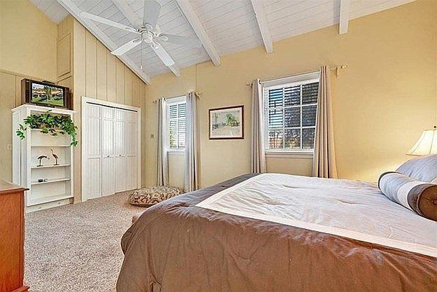 Master bedroom with vaulted ceiling and closet