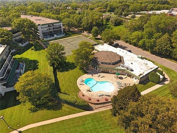 view from the top of outdoor pool and tennis court