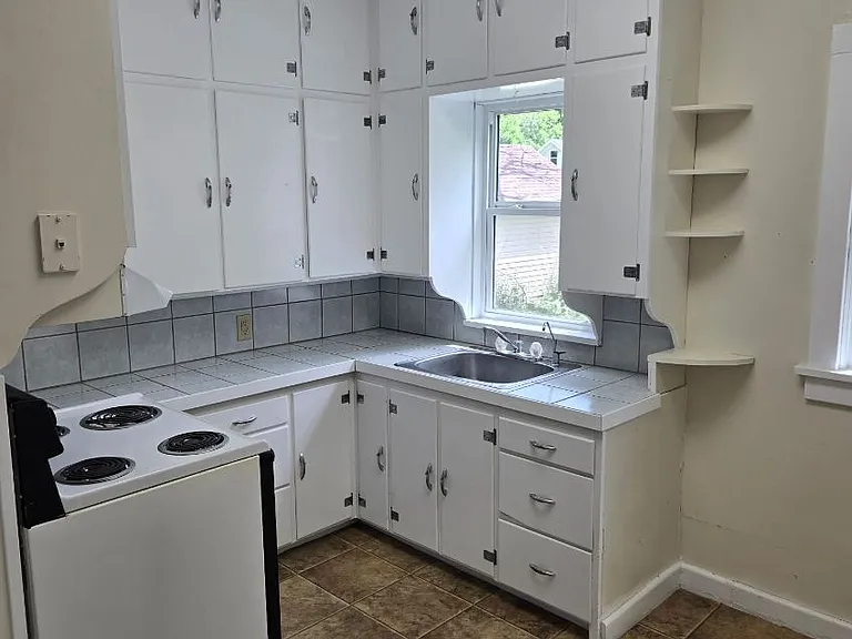 Kitchen has lots of storage and is very bright.