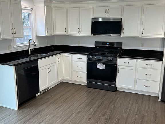 Kitchen with black granite countertops