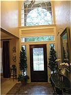 Entry--with upgraded large tile,leaded glass door! Plenty of light to the entry, with the arched window above