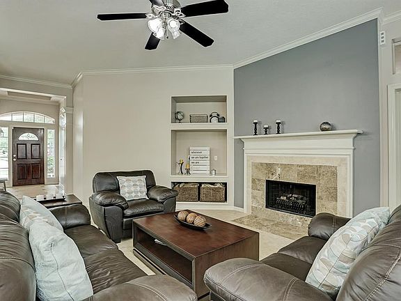 As you walk past the dining room, you will enter into the great room with a large living room, a kitchen with a huge island, and a breakfast room. This is a view looking back at the entryway.