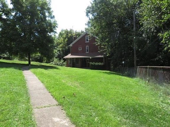 Huge fenced yard with double garage, greenhouse, & workshop.