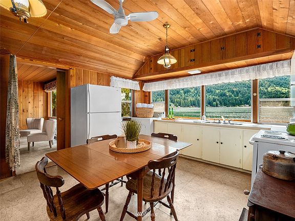 Open eat in kitchen with an abundance of windows to keep an eye on the beach while you cook. Appliances stay with cabin.