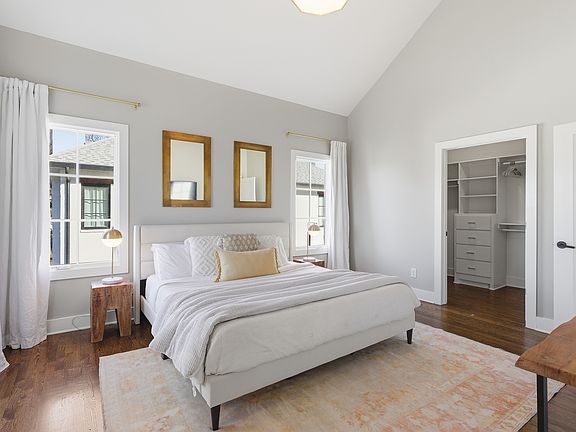 Primary bedroom on the 3rd floor with a king bed, Smart TV, ensuite bath, and room darkening shades. Includes a large walk-in closet. Tastefully decorated with high-end modern furnishings.