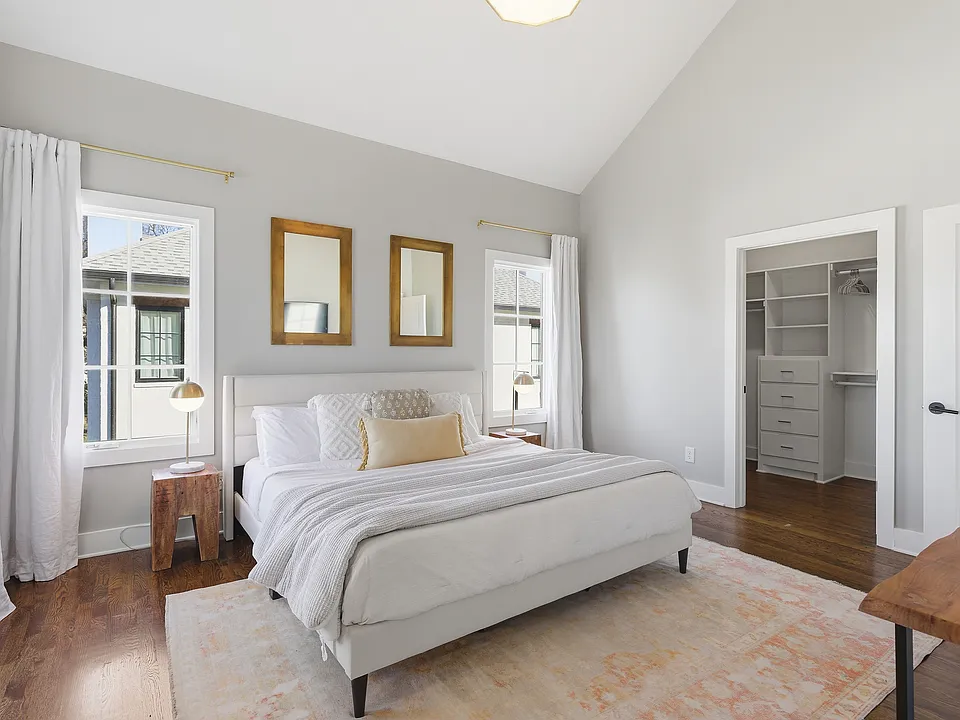 Primary bedroom on the 3rd floor with a king bed, Smart TV, ensuite bath, and room darkening shades. Includes a large walk-in closet. Tastefully decorated with high-end modern furnishings.
