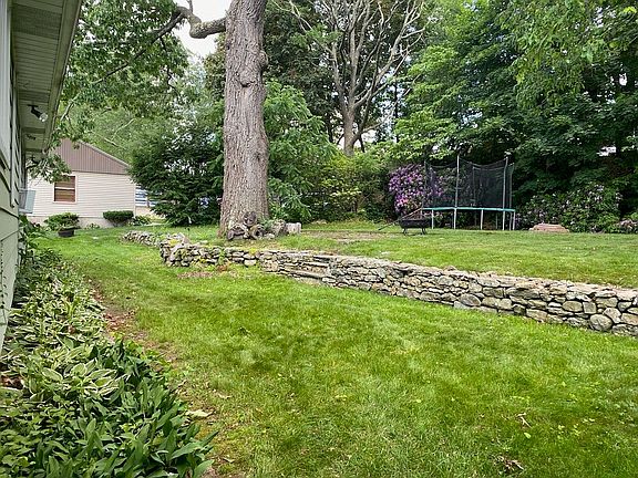 Back yard with stone wall.
