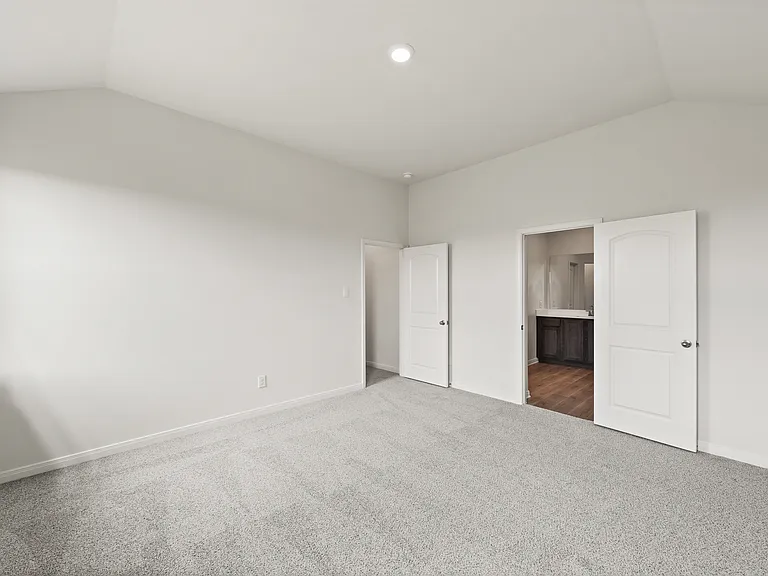 The master suite has a spacious bedroom, en-suite bathroom and walk-in closet.