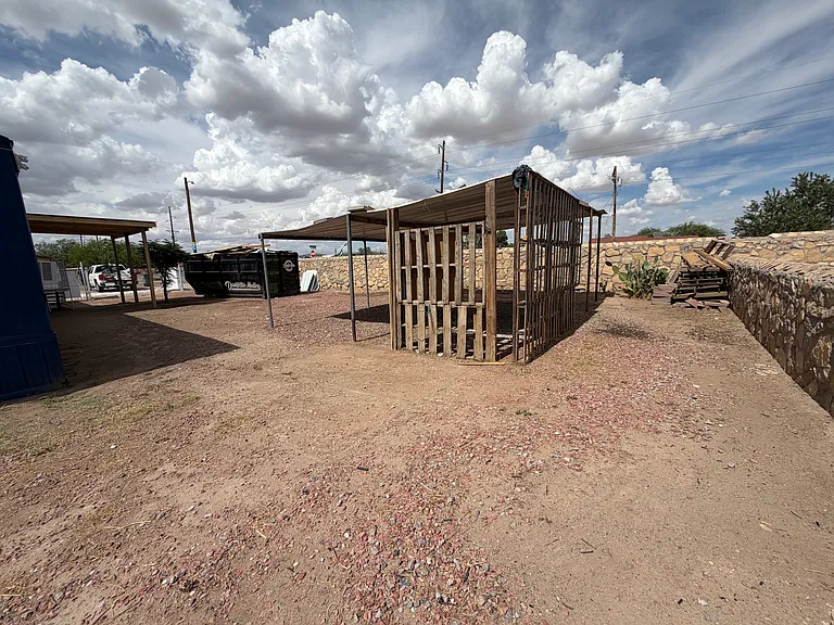 Large Yard with lots of parking very, rock wall and wire fence around entire property.