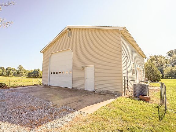 Outbuilding is 53' x 40' with 2 overhead doors, bathroom, heated and cooled.