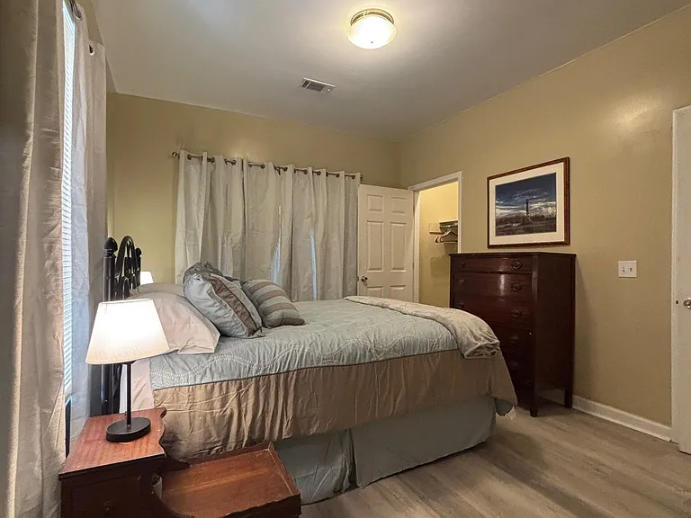 Attractive and comfortable primary suite with blackout drapes.